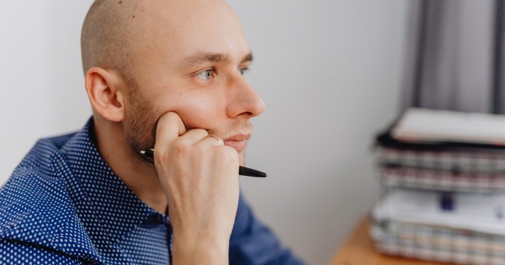 Thoughtful adult man looking ahead, questioning his health, lifestyle, and future.